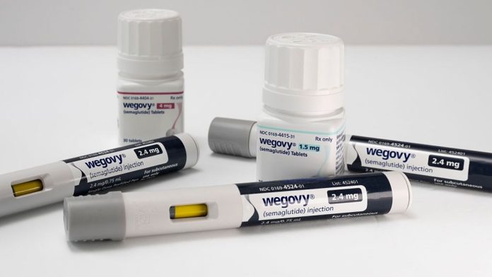 Photo Illustration of the new Wegovy 1.5 and 4 mg semaglutide tablets with injectable prescription weight loss pens on a white background.